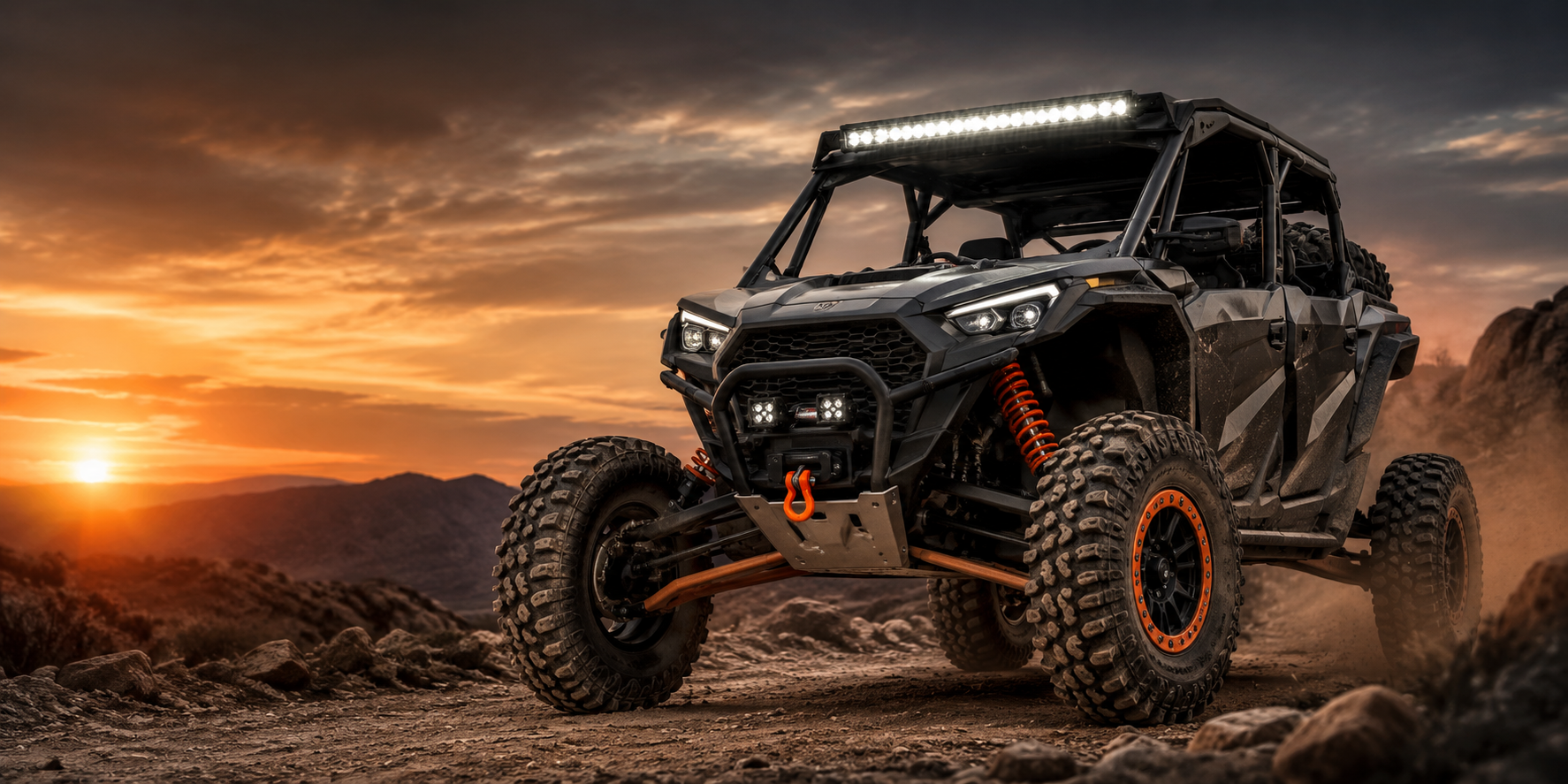 Side-by-side UTV driving through rugged off-road terrain with upgraded tires, suspension, lighting, and recovery gear in an Elite Offroad style